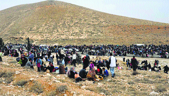 Syrian residents flee their homes following clashes between opposition fighters and forces loyal to Syria’s President Bashar al-Assad in the Adra area, east of Damascus