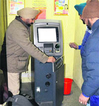 Police conduct investigation after an ATM machine was found open on the Police Lines road in Jalandhar on Wednesday night. 