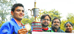 Nitin with his trophy and coaches on his arrival in Ludhiana on Thursday.