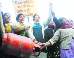 Members of the BJP Mahila Morcha stage a protest against the hike in price of LPG at Clock Tower in Ludhiana on Thursday. 