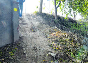 The damaged boundary wall of PAU on Canal Road. 