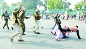 Policemen lathicharge BJP workers protesting against the alleged involvement of HP Chief Minister Virbhadra Singh in a corruption case, in Lucknow on Thursday.