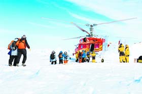 A helicopter air-lifting the passengers from the stranded Russian ship, MV Akademik Shokalskiy, off Antarctica on Thursday