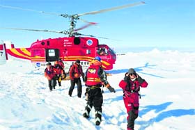 Passengers of the stranded Russian ship, MV Akademik Shokalskiy, arrive at a safe place in Antarctica on Thursday