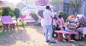 Attendents of patients sit on cemented chairinat the Civil Hospital in Amritsar.