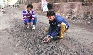 Residents show the damaged road near the Fort area in Bathinda on Friday.
