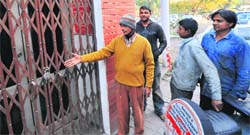 Workers show the closed public toilet at the motor market in Sector 38, Chandigarh. Tribune Photo: Pradeep Tewari