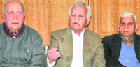 Air Marshal Randhir Singh (retd), flanked by residents, addresses mediapersons at his residence in Sector 35, Chandigarh, on Friday. Tribune photo: S Chandan