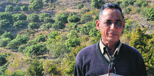 Jawahar Singh of Parogi village in front of his mango orchard. 