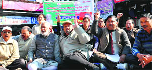 Workers of the UKD hold a protest at Clock Tower in Dehradun on Friday. 