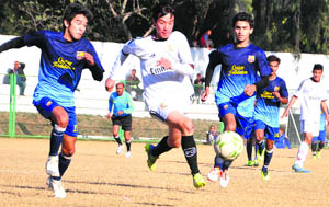 Players in action during a match in the Swami Vivekanand Memorial District Football Tournament at the Pavillion ground in Dehradun on Friday. 