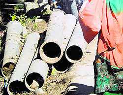 Sewerage pipes rust by the roadside in Kangra town