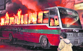 A bus torched by Opposition party workers in Dhaka. AP/pti