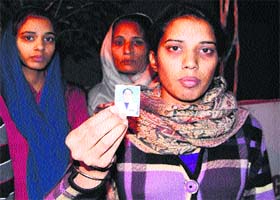 A family member of a dowry death victim, Amandeep Kaur, shows the picture of the deceased, who was allegedly killed by her in-laws in Amritsar on Saturday