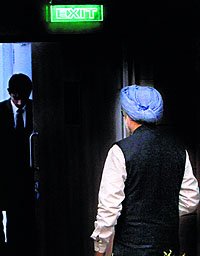 Prime Minister Manmohan Singh leaves after addressing the press conference in New Delhi on Friday