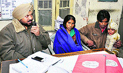 A police official makes announcement about the missing child at the Jalandhar railway station on Saturday evening