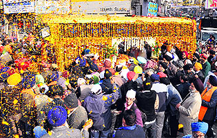 Devotees take part in a nagar kirtan on the occasion of the birth anniversary of Guru Gobind Singh in Jalandhar on Saturday