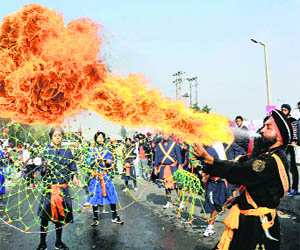 Devotees perform during a religious procession ahead of the birth anniversary of Guru Gobind Singh in Jammu on Saturday.