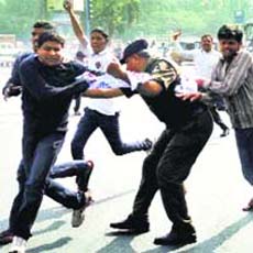 Policemen detain students protesting for Telangana outside the Andhra Pradesh Assembly in Hyderabad on Saturday