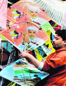 A kite seller decorates his shop with Modi-kites ahead of festival of Sankranti in Indore on Saturday