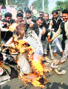 People burn Uttar Pradesh CM Akhilesh Yadav's effigy during protest against corruption in Uttar Pradesh Public Service Commission, in Allahabad on Saturday