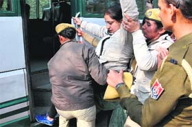 A member of the Unaided Teachers of Aided Schools Front, Punjab, being rounded up by the police in Bathinda on Sunday