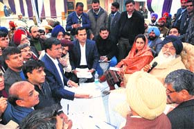 Chief Minister Parkash Singh Badal along with MP Harsimrat Kaur Badal listens to grievances of the people during a sangat darshan in Bathinda on Sunday