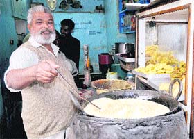 Mangal prepares samosas at his shop located behind the bus stand in Bathinda