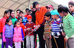 Ace golfer Jeev Milkha Singh gives tips to young golfers at the inaugural ceremony of the synthetic green turf at the Chandigarh Golf Range on Sunday