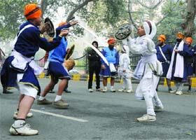 Children perform martial arts during a procession on the occasion of Parkash Utsav of Guru Gobind Singh in New Delhi on Sunday