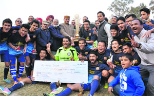 The Vijay Cantt team celebrate after winning the football tournament in Dehradun on Sunday.