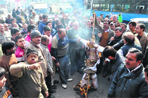 Traders hold a protest at Saharanpur Chowk in Dehradun on Saturday.