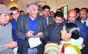 Chief Minister Vijay Bahuguna listens to a woman during a janta darbar in Dehradun on Sunday. 