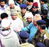 Cooperation and Housing Minister Satpal Sangwan tries to pacify protesters at Bond Kalan village in Bhiwani district on Sunday. 