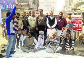 Members of the Bijli Andolan Samiti sit on a dharna at Bhagat Singh Chowk in Sirsa on Saturday.