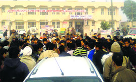 Residents of Silothi village hold a protest at Bahadurgarh town in Jhajjar on Sunday.
