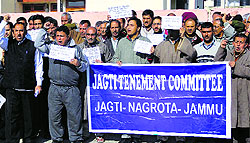 Members of the Jagti Tenement Committee holding a protest at the Jagti migrant camp in Nagrota on Sunday