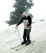 A man skis on the slopes of Gulmarg