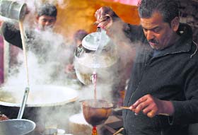 A vendor prepares tea at his roadside stall in Delhi on Sunday