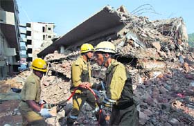 Rescuers search for survivors at the site where a building collapsed in Goa on Sunday