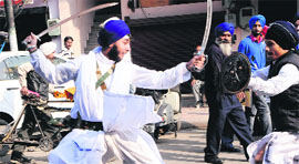 Sikh boys perform gatka during a religious procession on the eve of the birth anniversary of Guru Gobind Singh in Amritsar on Monday.