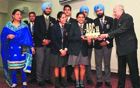 Shamim Khan, principal of the Aitchison College, Lahore, Pakistan, gives award to students of YPS, Mohali, on Monday