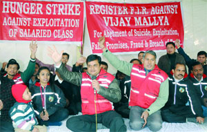 Employees of Kingfisher Airlines stage a dharna against their chairman Vijay Mallya for abetting suicide, fraud, etc., at Jantar Mantar in New Delhi on Monday.
