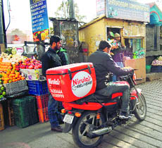 A home delivery boy bound by time, speeding on a motorcycle in Mussoorie on Monday. 