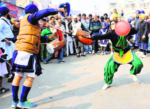 A girl displays her gatka skills during a nagar kirtan procession on the eve of Guru Gobind Singhs birth anniversary in Karnal on Monday.