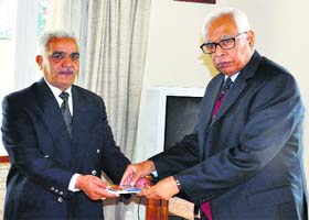 PL Koul presents a copy of Kashmiri Pandits  Bujhe Chirag to Governor NN Vohra at Raj Bhawan in Jammu on Monday