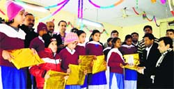 Members of the Asian Club distribute items among children of the Vocational Rehabilitation Training Centre in Ludhiana on Monday. Photo: Inderjeet Verma 