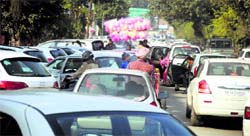 In the absence of proper parking lots, vehicles parked haphazardly cause a snarl-up on a Ludhiana road. Tribune Photo: Himanshu Mahajan