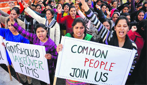 Employees of the Punjab Institute of Medical Sciences protest against the state government in Jalandhar on Monday.