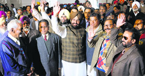 PPCC president Partap Singh Bajwa (centre) waives at party workers on his arrival at the Congress Bhawan in Chandigarh on Monday. 